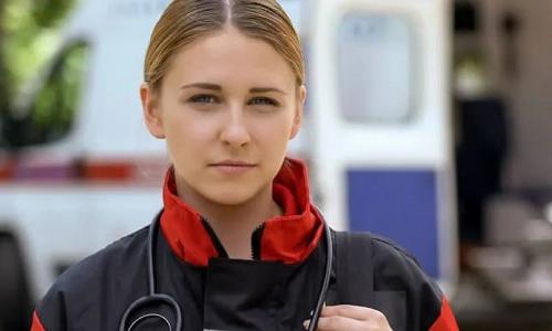 EMT with Certificate in Birmingham Standing Outside Ambulance