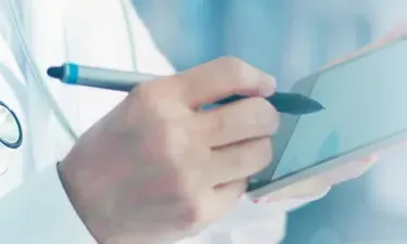 Medical Office Administrator Taking Notes on Clipboard