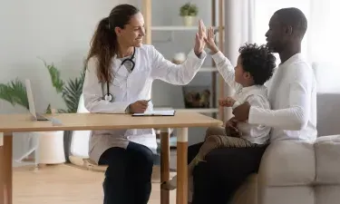 Family Nurse Practitioner FNP High Fiving Child Patient