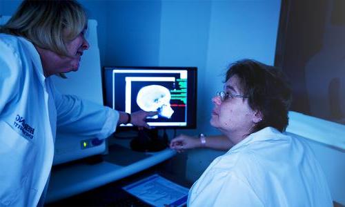 Radiologic technologists in Orlando hospital reviewing patient x-ray results